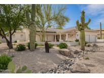 Stunning single-story home featuring desert landscaping with mature Saguaro cacti and a charming pergola-covered entry at 22756 N 91St Way, Scottsdale, AZ 85255