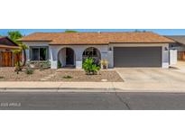 Charming single-story home with a well-maintained yard and attached two-car garage at 2444 S Noche De Paz --, Mesa, AZ 85202