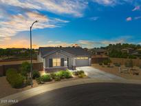 Charming single-story home featuring a two-car garage, well-maintained landscaping, and a welcoming entrance at 435 E Shellie Ct, Casa Grande, AZ 85122