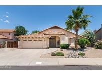 Charming single-story home with a well-manicured front yard and desert landscaping in a sunny setting at 5132 E Grandview Rd, Scottsdale, AZ 85254