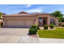 Charming home featuring a well-manicured lawn and a spacious three-car garage, perfect for suburban living at 7231 W Lone Cactus Dr, Glendale, AZ 85308