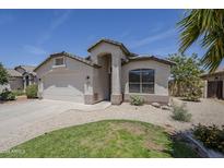 Charming single-story home with desert landscaping, lawn, and attached two-car garage on a sunny day at 9330 E Plana Ave, Mesa, AZ 85212