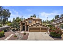 Charming two-story home with stucco exterior, three-car garage, and manicured front yard at 1244 W Straford Ave, Gilbert, AZ 85233