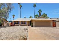 Charming single-story home with a two-car garage, low maintenance desert landscaping, and a welcoming entrance at 1712 E Manhatton Dr, Tempe, AZ 85282