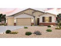 Charming single-story home featuring a three-car garage, desert landscaping, and beautiful architectural details at 17770 W Fulton St, Goodyear, AZ 85338