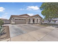 Charming single-story home with a well-manicured front yard and an attached two-car garage at 18998 E Lark Dr, Queen Creek, AZ 85142