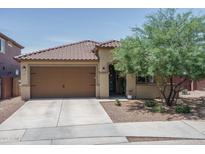 Charming single-story home featuring a well-maintained yard, tile roof, and a two-car garage at 25560 N 164Th Dr, Surprise, AZ 85387