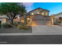Charming two-story home featuring a three-car garage, desert landscaping, and classic Southwestern architecture at 3859 N El Sereno St, Mesa, AZ 85207