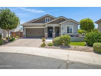 Charming single-story home featuring a lush landscaped yard and a welcoming two-car garage at 41465 W Sussex Dr, Maricopa, AZ 85138