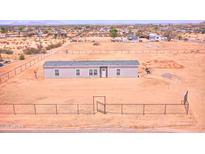 New single-story home with a gray roof and ample land, enclosed by a chain-link fence at 47654 W Venado Rd, Maricopa, AZ 85139