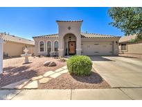 Charming single-story home featuring a well-manicured yard and an inviting arched entryway at 709 E Dry Creek Rd, San Tan Valley, AZ 85143