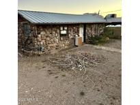 Charming stone house featuring a metal roof and a rustic exterior at 829 W Spray St, Superior, AZ 85173