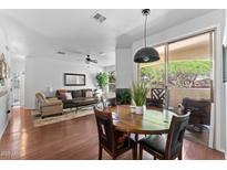 Bright dining area features a wood table and access to outdoor balcony, seamlessly blending indoor and outdoor living at 9550 E Thunderbird Rd # 214, Scottsdale, AZ 85260