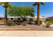 Charming single-story home with desert landscaping, mature trees, and a well-maintained front yard at 9623 N 34Th Pl, Phoenix, AZ 85028