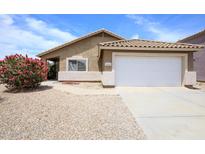 Charming single-story home featuring a well-manicured yard and an attached two-car garage at 10334 E Diamond Ave, Mesa, AZ 85208
