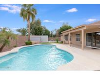 Refreshing pool with palm trees and a storage shed in a well-maintained backyard at 10845 W Quail Ave, Peoria, AZ 85373