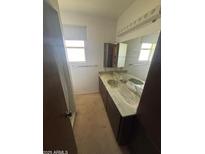Neutral bathroom featuring a marble countertop, a mirror, and natural light at 121 E Ivanhoe St, Gilbert, AZ 85295