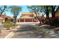 Inviting two-story home with tile roof, lush landscaping, and a two-car garage at 14021 N 29Th St, Phoenix, AZ 85032