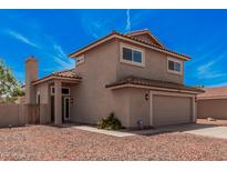 Two-story home featuring a terra cotta roof, two-car garage, and desert landscaping at 15440 S 38Th St, Phoenix, AZ 85044