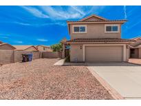 Front exterior of tan two-story home with red rock landscaping and driveway at 15440 S 38Th St, Phoenix, AZ 85044