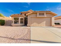 Single Gathering home with large window and two-car garage, landscaping with desert rock and a terracotta roof at 1627 W Maplewood St, Chandler, AZ 85286