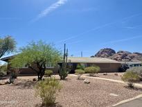 Charming home featuring desert landscaping, mature trees, and mountain views at 2319 N 58Th St, Scottsdale, AZ 85257
