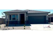 Charming single-story home featuring a two-car garage, low maintenance landscaping, and a welcoming entrance at 25096 N 154Th Ln, Surprise, AZ 85387