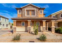 Inviting two-story home with a covered porch and desert landscaping at 34913 N 30Th Dr, Phoenix, AZ 85086