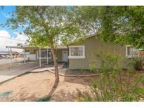 Charming single story home features a carport, desert landscaping, and a covered front porch at 3802 N 50Th Ave, Phoenix, AZ 85031