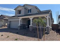 Beautiful two-story home featuring a covered porch and desert landscaping at 3811 S Bridlewood Ave, Mesa, AZ 85212