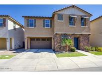 Charming two-story home featuring stone accents, a two-car garage, and a well-manicured front yard at 4242 E Erie St, Gilbert, AZ 85295
