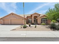 Charming single-story home with a three-car garage, desert landscaping, and a tiled roof at 4401 E Barwick Dr, Cave Creek, AZ 85331