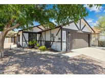 Charming Tudor-style home featuring a well-maintained front yard and two-car garage at 4808 E Betty Elyse Ln, Scottsdale, AZ 85254