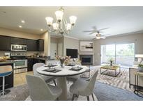 Bright and airy living room with a dining area and fireplace, leading to a balcony with natural light at 5345 E Van Buren St # 305, Phoenix, AZ 85008