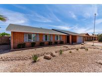 Charming brick home featuring a well-maintained yard and shuttered windows at 5721 W Palo Verde Ave, Glendale, AZ 85302