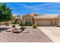Charming single-story home featuring a desert landscape, tile roof and an attached two-car garage at 5830 E Mckellips Rd # 120, Mesa, AZ 85215