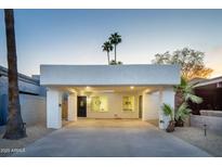Charming home featuring a covered carport, desert landscaping, and a stylish front door at 628 N Hobson --, Mesa, AZ 85203