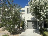 Inviting two-story home featuring lush landscaping and a two-car garage in a well-maintained neighborhood at 7710 E Gainey Ranch Rd # 142, Scottsdale, AZ 85258