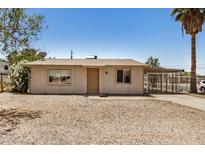Charming single-story home with a gravel yard and a covered parking area in a sunny, suburban setting at 8101 E 4Th Ave, Mesa, AZ 85208