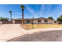 Charming single-story home with a well-maintained lawn, mature palm trees, and a spacious driveway at 8124 N 45Th Ave, Glendale, AZ 85302
