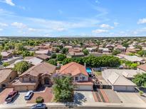 Expansive aerial view of a vibrant neighborhood with tidy homes, beautiful landscaping, and a stunning mountain backdrop at 8931 W Alex Ave, Peoria, AZ 85382