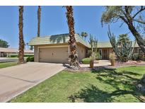 Charming single-story home with desert landscaping, mature trees, and a two-car garage at 10648 W Loma Blanca Dr, Sun City, AZ 85351