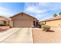 Charming single-story home featuring a two-car garage and desert landscaping for low maintenance at 13022 W Cherry Hills Dr, El Mirage, AZ 85335