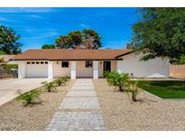 Charming single-story home with desert landscaping, brick pathway, and white pillars at 1304 W Ocotillo Rd, Phoenix, AZ 85013