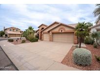 Charming single-story home featuring a three-car garage, desert landscaping, and neutral color palette at 15809 S 31St St, Phoenix, AZ 85048