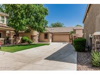 Charming single-story home features stucco siding, a tiled roof, and a spacious driveway leading to an attached garage at 15941 N 171St Ln, Surprise, AZ 85388