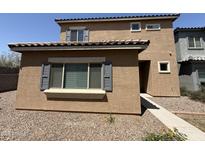 Tan two-story home showing front entrance and landscaped ground cover at 1725 W Pollack St, Phoenix, AZ 85041