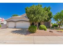 Charming home featuring a spacious three-car garage and mature landscaping, offering great curb appeal at 1802 W Encinas St, Gilbert, AZ 85233