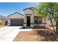 Charming single-story home featuring a low-maintenance front yard and a welcoming entryway at 18711 W Farmer Rd Rd, Buckeye, AZ 85326
