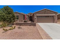 Charming single-story home with a well-maintained desert landscape, patio, and two-car garage at 20211 N Winter Escape Ct, Maricopa, AZ 85138